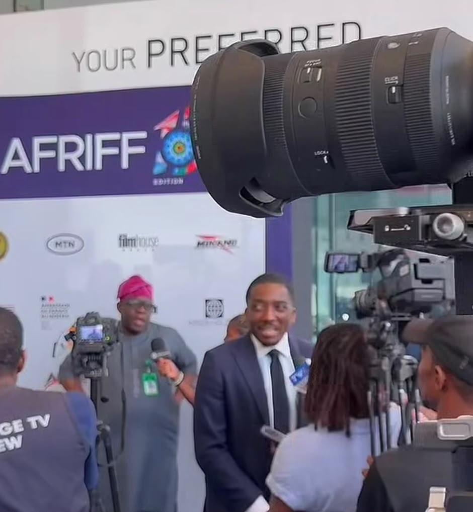 Comedian and actor Bovi Ugboma speaking to reporters at the AFRIFF 2026 press wall in Lagos